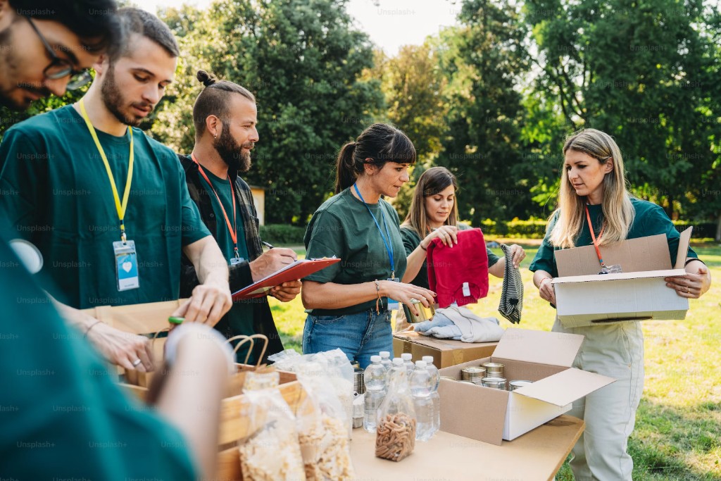 Volunteers packing donated food and supplies at an outdoor drive